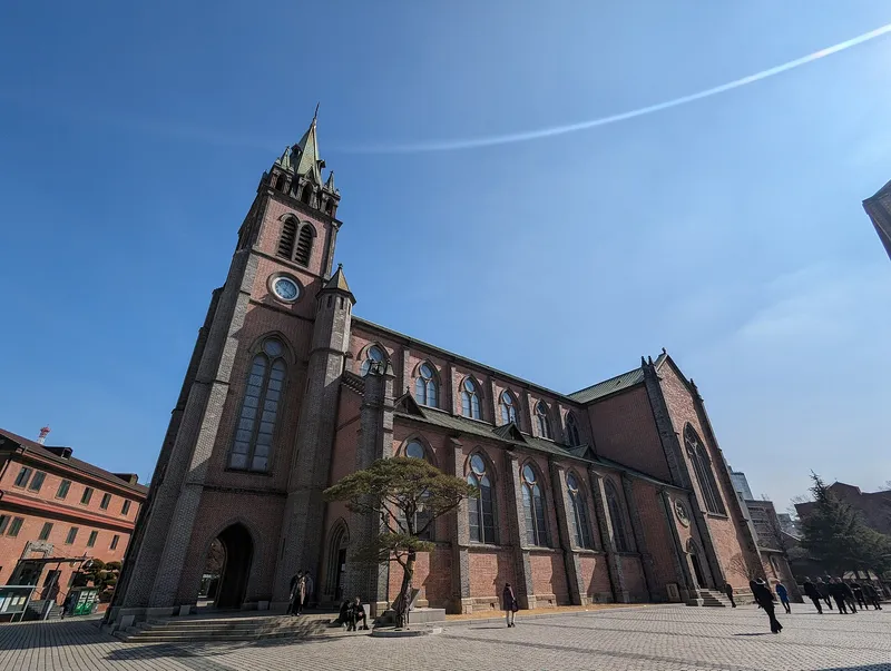 Myeongdong Cathedral's red-brick front under a blue sky